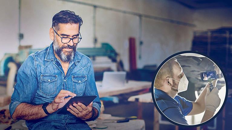 Man with ipad checking progress of Ford service