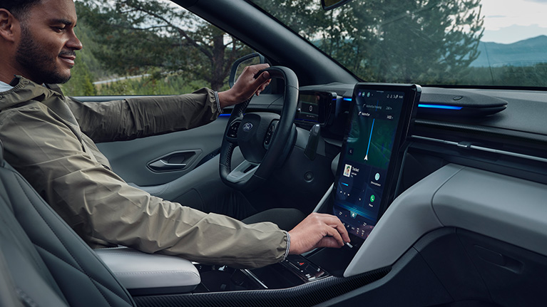 Man using touchscreen in Ford Electric Explorer